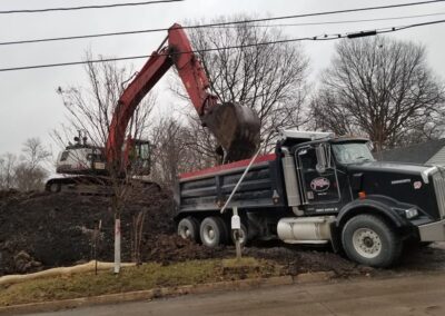 Excavator loading a dump truck for export dirt
